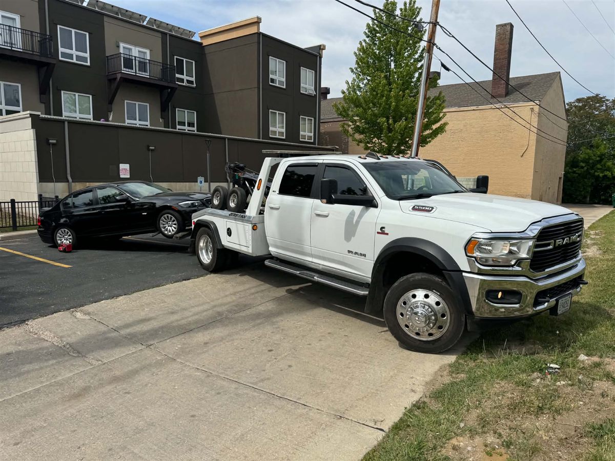 we buy junk cars Milwaukee, loading a sedan from an apartment parking lot