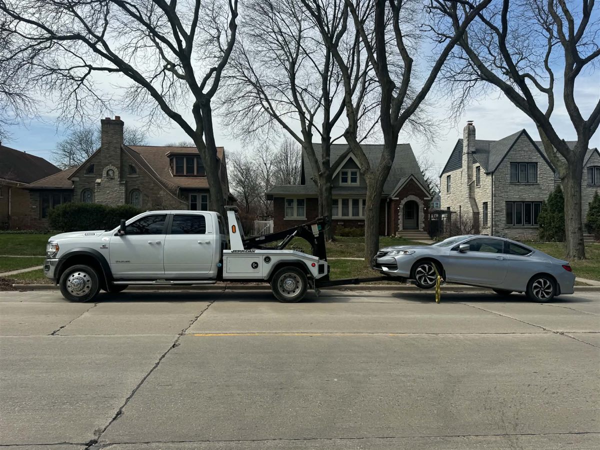 we buy junk cars Milwaukee, our wrecker loading a silver Honda Accord coupe