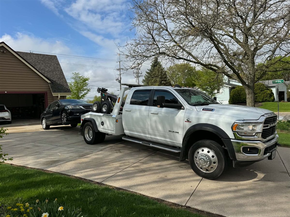 we buy junk cars Milwaukee, picking up a black Honda Accord from a home driveway