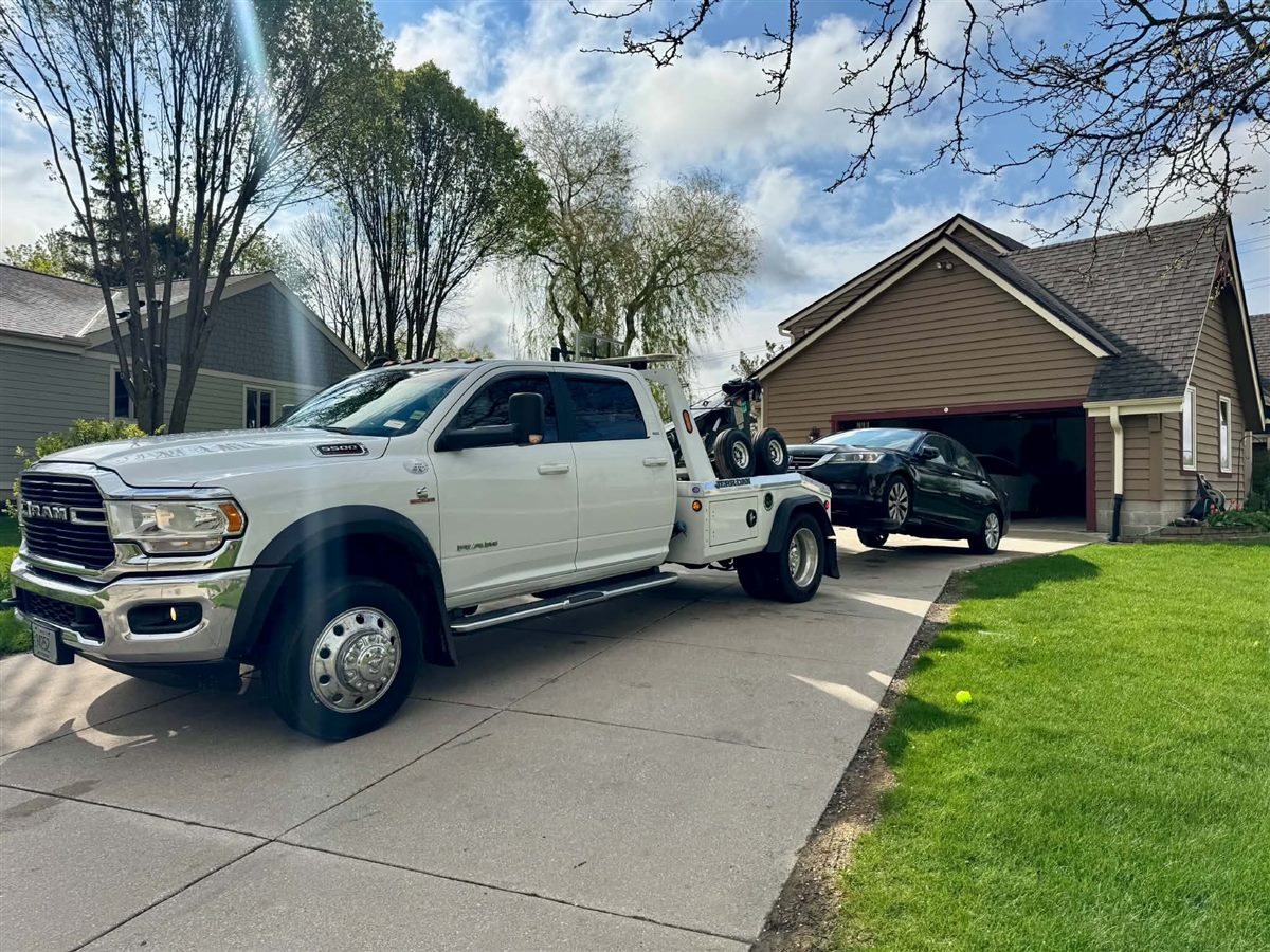 we buy junk cars Milwaukee, removing a black Honda Accord from a driveway